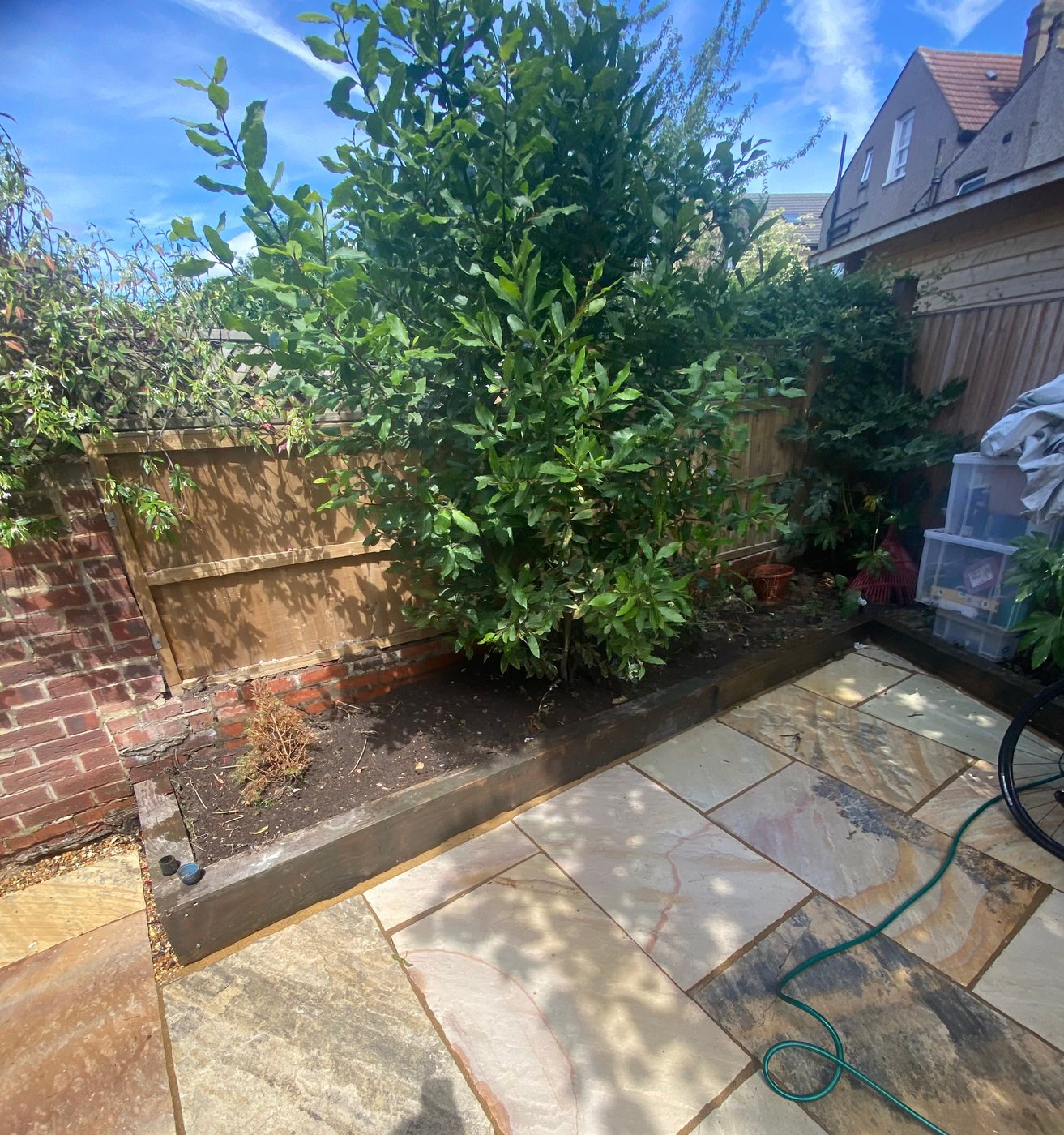Indian sandstone patio with planted border