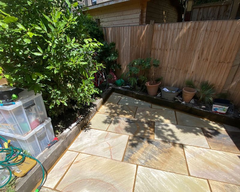 Indian sandstone patio in a landscaped garden by White&Son